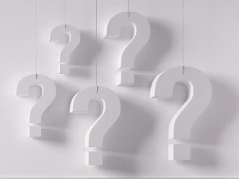 Five white question marks on a light background.