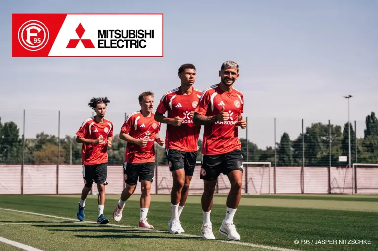 Photo of four Fortuna players running on a practice field