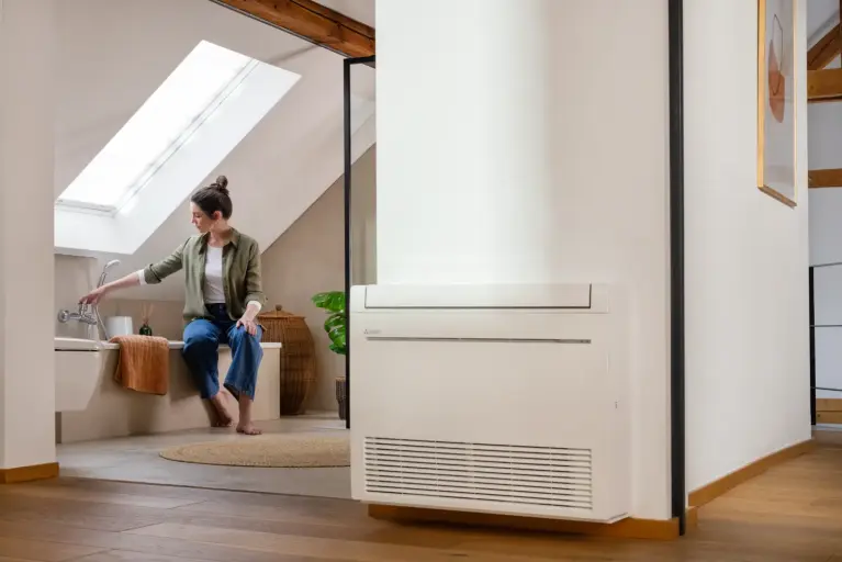 Photo of a woman in the bathroom, with a chest of drawers in the foreground